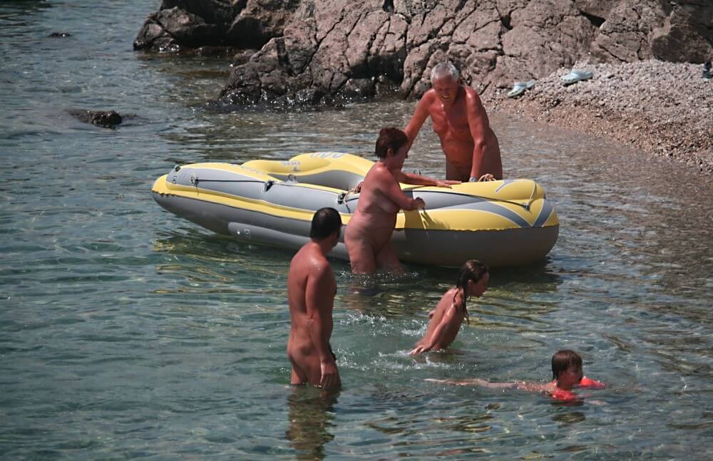 Lone Nudist in Yellow Boat photos - A nudist values simplicity in life and naturalness in expression