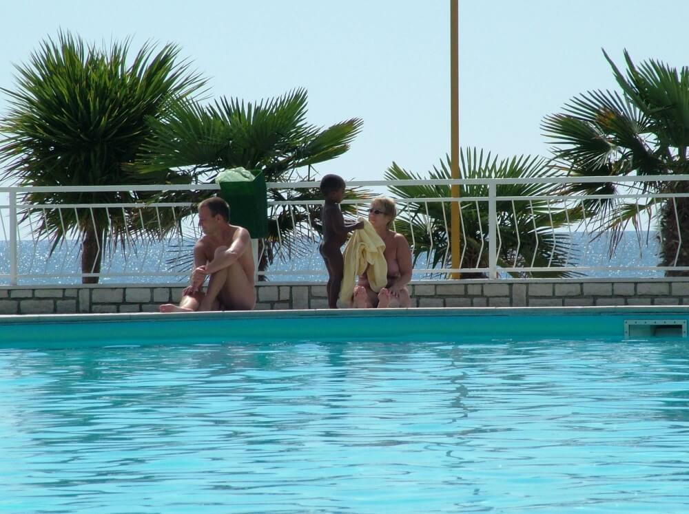 Photo of naturists in an outdoor pool - Nudity in naturism is not usually an end in itself